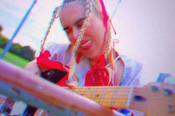 SUUNCAAT with braids playing guitar
