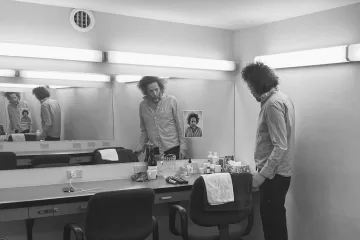 Destroyer Press Photo for Dan's Boogie. Dan Bejar in black and white in what looks like a changing room.